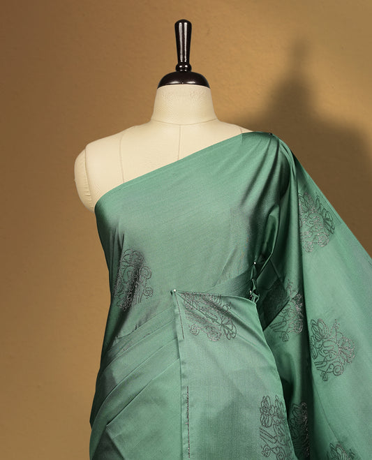Soft aqua green colour semi soft silk saree featuring self woven motifs on the body, elegant woven border, and rich matching pallu with tassel finish & Comes with a coordinating blouse piece for a graceful look.