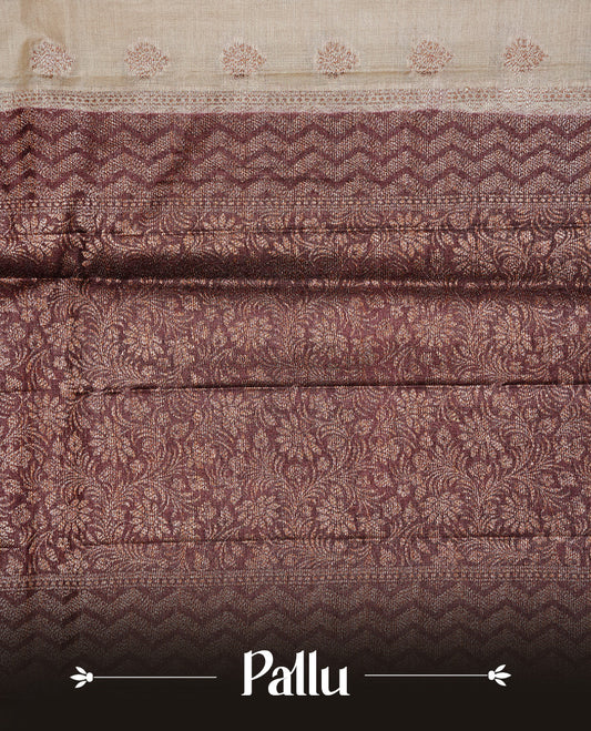 Cream Colour Tussar silk saree featuring Antique Zari motifs on body, Finished with contrast Chocolate colour Zigzag zari pattern border, paired with matching blouse piece.