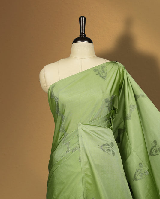 Pastel green colour semi soft silk saree adorned with delicate woven motifs on the body & Enhanced with a contrast zari border and elegant pallu with tassels, paired with a matching blouse.