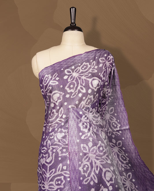 Lavender semi jute tissue saree adorned with elegant white floral motifs all over the body, paired with a beautifully woven pallu and patterned borders & Comes with a matching blouse piece.
