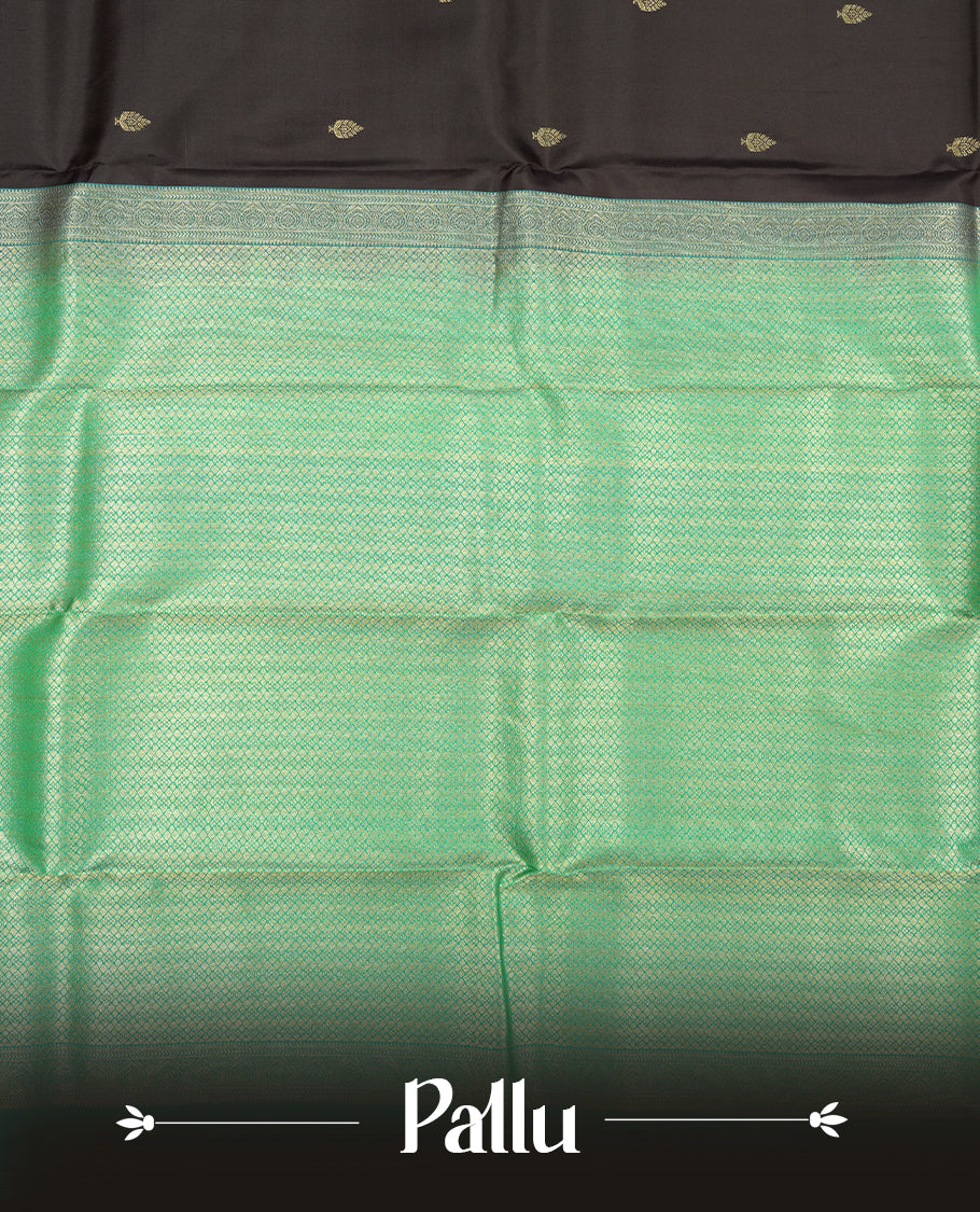 Dark purple colour Vasundhara silk saree adorned with all-over gold motifs on the body, complemented by a contrast green with gold tarditional border and paired with a matching blouse piece.