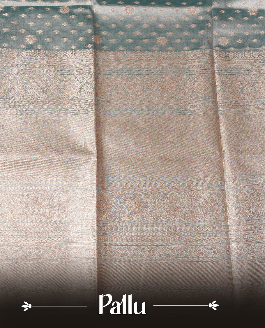 Pastel Aqua colour semi tissue silk saree featuring floral zari motifs on body, complemented by gold zari traditional border, paired with matching blouse piece.