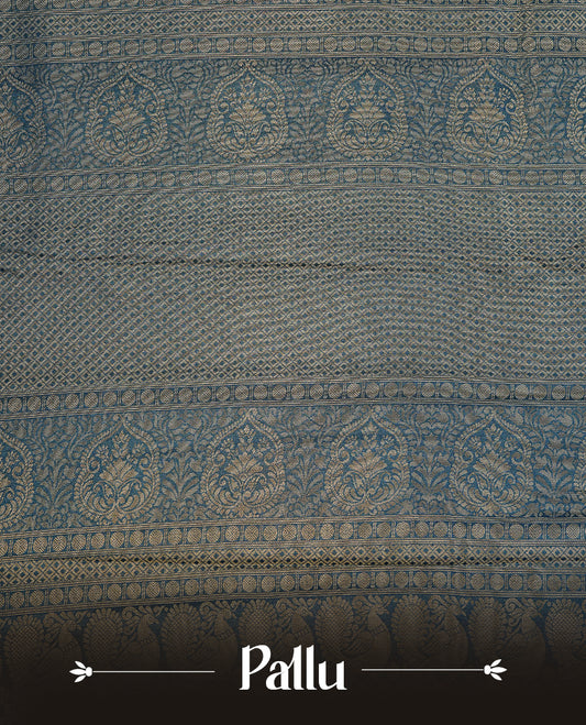 Navy blue colour soft silk saree featuring gold zari pattern on body, complemented by self colour with traditional border, paired with matching blouse piece.