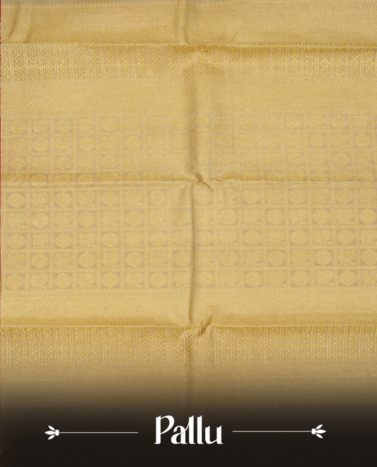 Black colour Traditional Kancheepuram silk saree featuring Gold zari Buttas, complemented by contrast beige colour with Orange zari floral pattern with traditional border, comes with matching blouse piece.