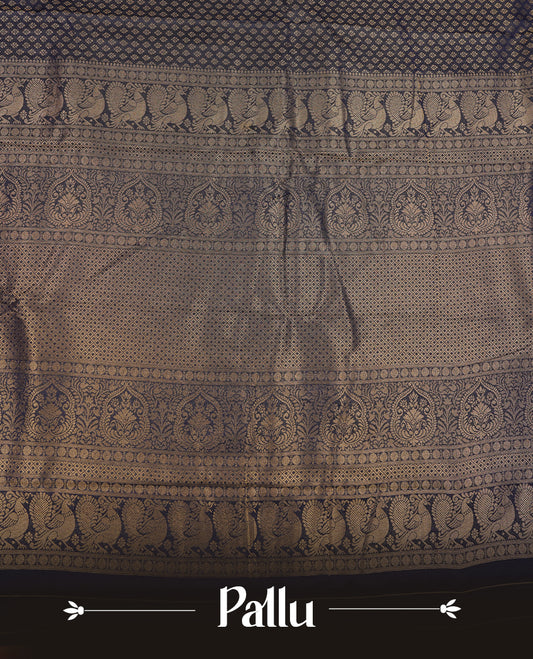 Navy blue colour semi soft silk saree featuring gold zari motifs on across body, self colour border with traditional gold zari pattern, pallu and paired with matching blouse.