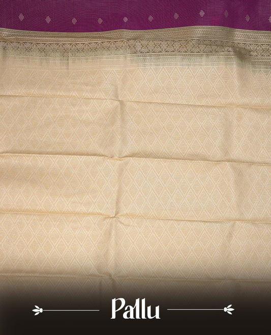 Purple coloured soft silk saree featuring gold zari stripes and motifs across the body, enhanced with a contrast Cream border and pallu, paired with a matching contrast blouse piece.