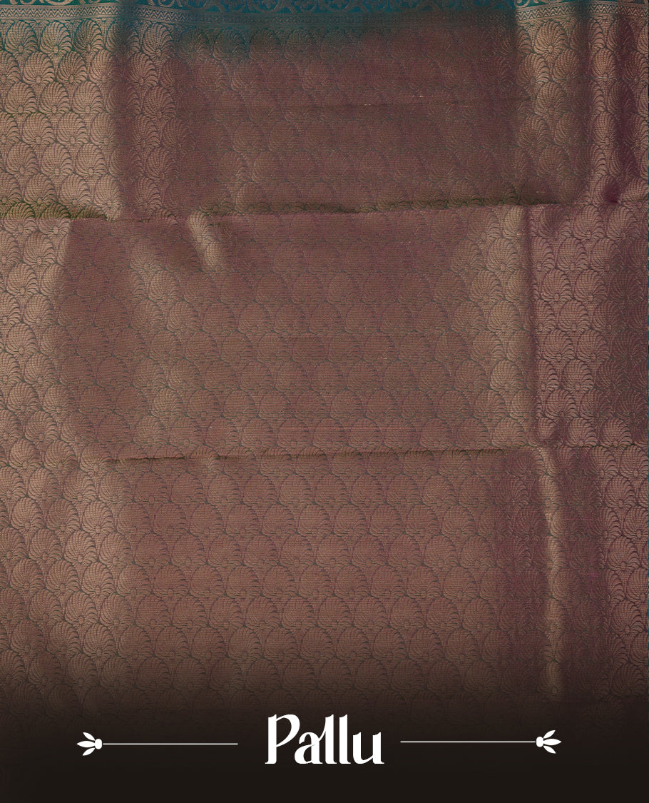 Peacock colour soft silk saree featuring gold zari motifs on the body, complemented by a contrast Magenta traditional zari floral kodi border and pallu, paired with a matching blouse piece.