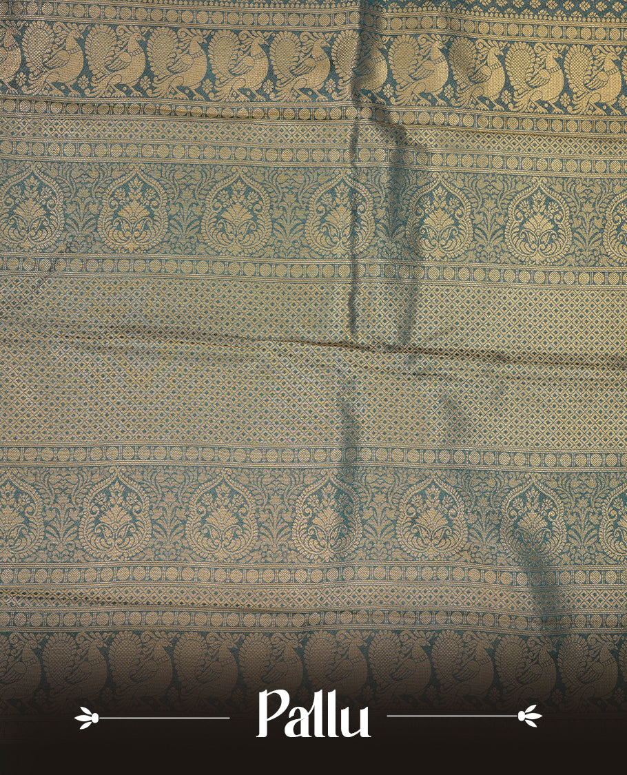Teal colour semi soft silk saree featuring gold zari motifs on across body, self colour border with traditional gold zari pattern, pallu and paired with matching blouse.