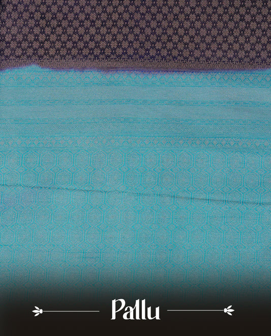 Deep purple colour softie silk saree featuring gold zari, rich pallu floral pattern brocade body, with contrasting teal blue colour border.paired with matching blouse piece.