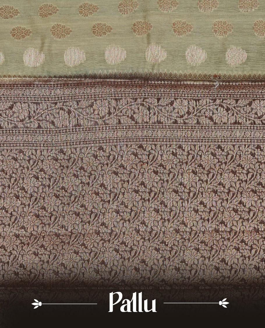 Pastel Olive Colour Tussar Silk saree with antique zari butta motifs On Body, a Brown floral zari border, a rich zari pallu, and a matching blouse piece.