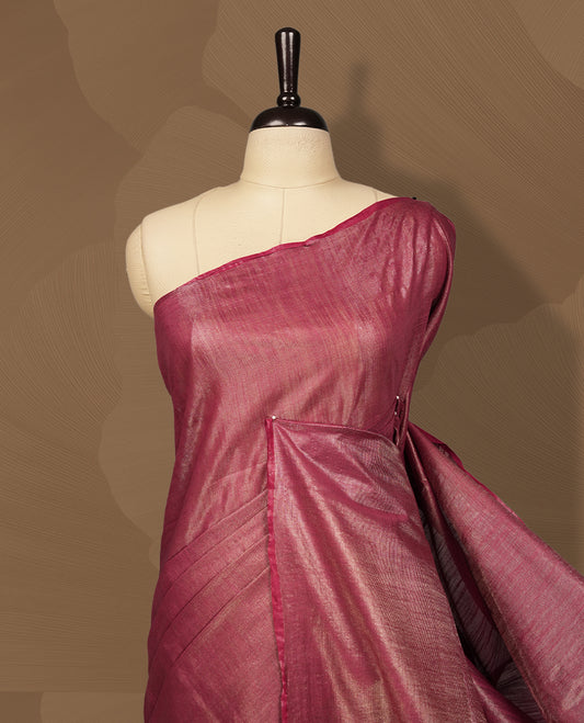 Burgundy brown colour semi jute tissue saree featuring delicate wave motifs on the body, complemented by a lustrous zari striped pallu and matching blouse piece for a refined festive look.