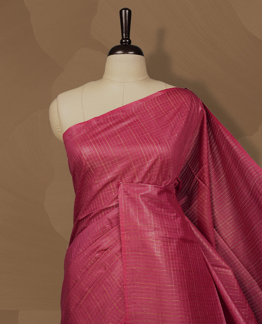 Medium maroon colour semi jute saree with golden checked body for a traditional appeal, Soft texture, tassel pallu, and Includes matching blouse piece for a complete look.