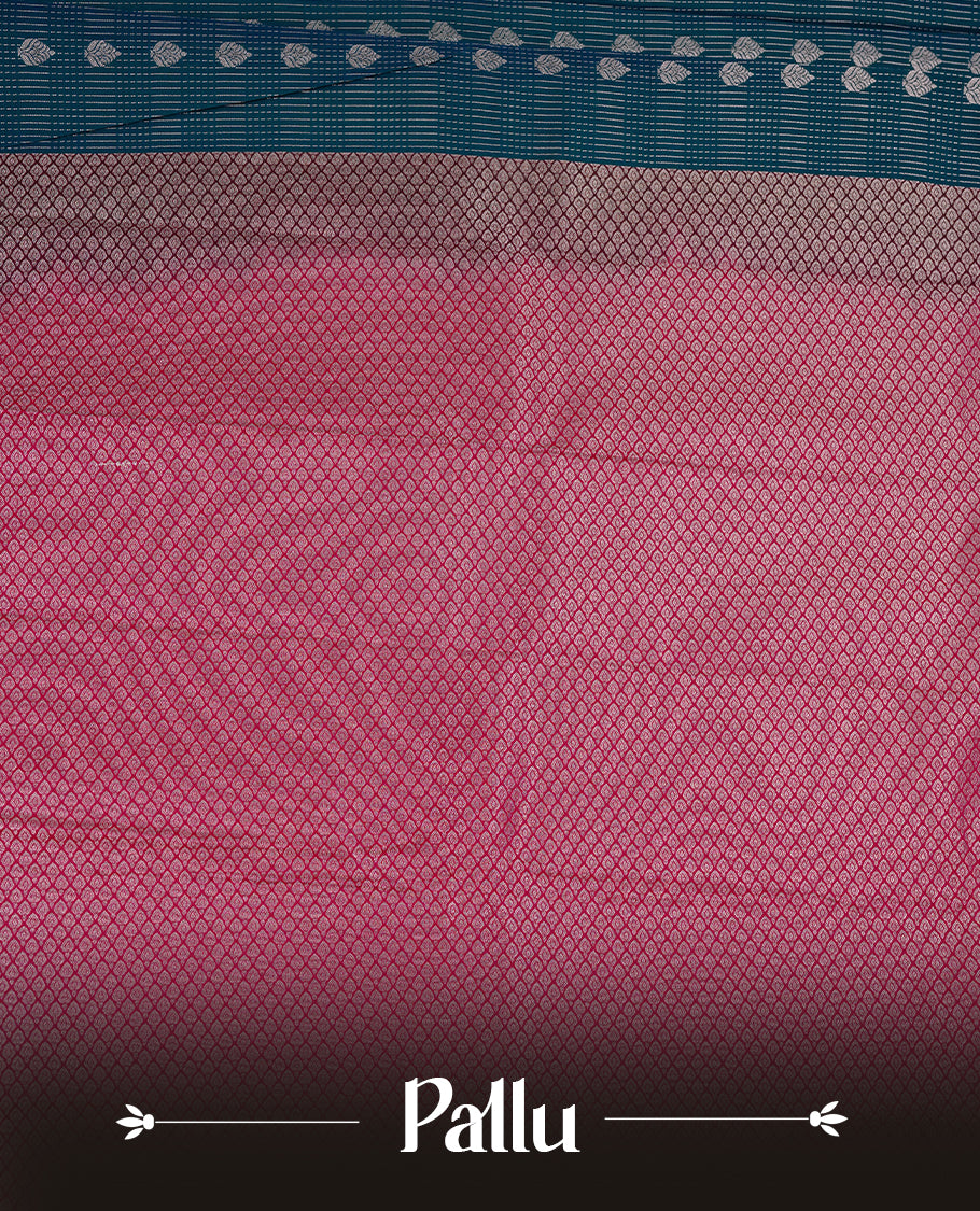 Teal coloured soft silk saree featuring gold zari stripes and motifs across the body, enhanced with a contrast Magenta border and pallu, paired with a matching contrast blouse piece.