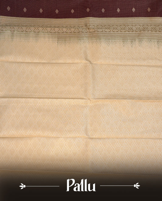Chocolate brown coloured soft silk saree featuring gold zari stripes and motifs across the body, enhanced with a contrast Cream border and pallu, paired with a matching contrast blouse piece.