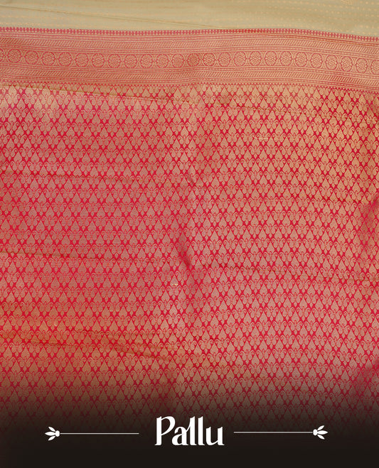 Cream coloured soft silk saree featuring gold zari dotted stripes and motifs across the body, enhanced with a contrast Magenta border and pallu, paired with a matching contrast blouse piece.