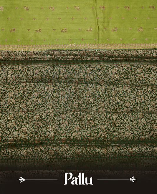Green colour Pure banaras soft silk saree featuring Antique zari motifs on body, contrast Dark green colour border , traditional pallu and paired with matching blouse