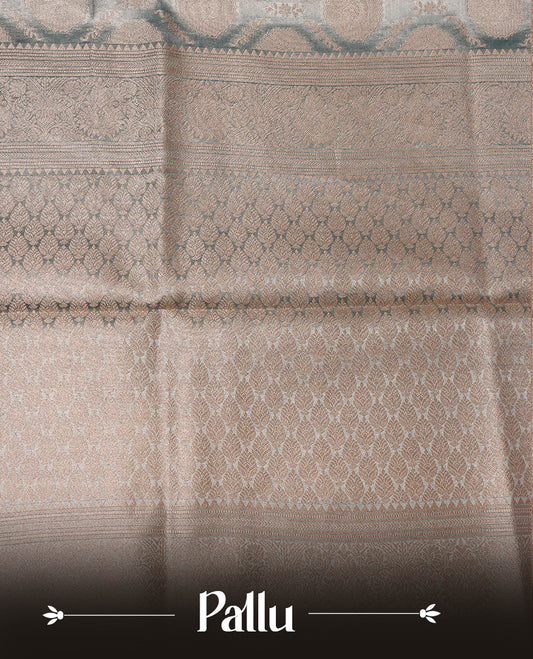 Pastel Blue colour semi tissue silk saree featuring floral zari motifs on body, complemented by gold zari traditional border, paired with matching blouse piece.