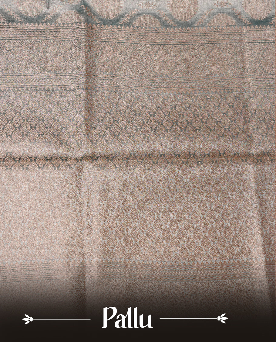 Pastel Blue colour semi tissue silk saree featuring floral zari motifs on body, complemented by gold zari traditional border, paired with matching blouse piece.