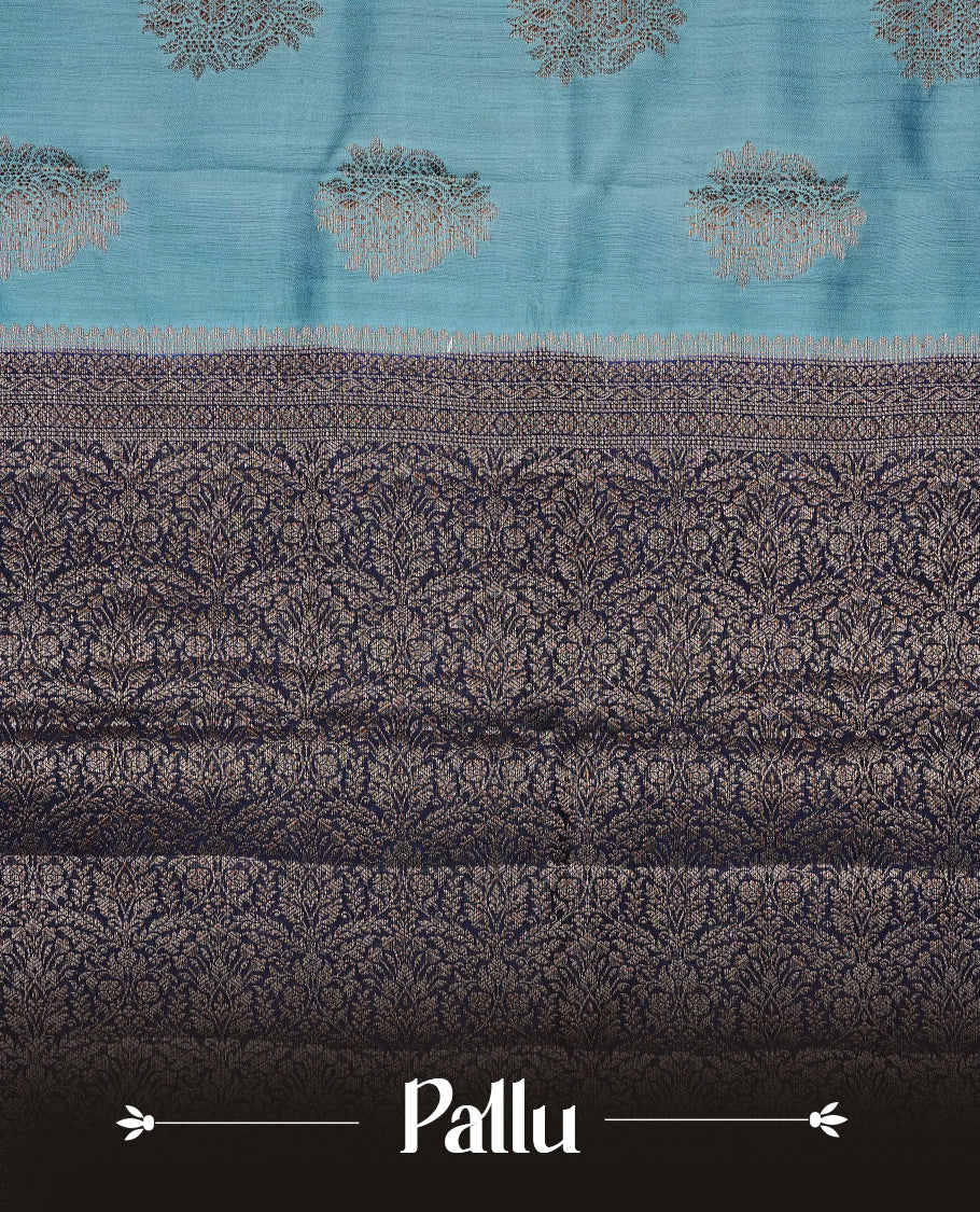 Pastel Aqua Colour Tussar Silk saree with elegant antique zari floral motifs On Body, a contrasting navy blue zari border, a rich zari pallu, Paired With a matching  blouse piece.