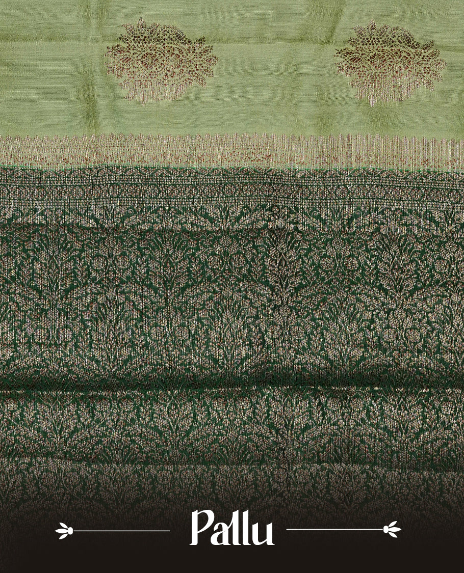 Pastel Pistachio Green Colour Tussar Silk saree with elegant antique zari floral motifs On Body, a contrasting dark green zari border, a rich zari pallu, and a matching blouse piece.
