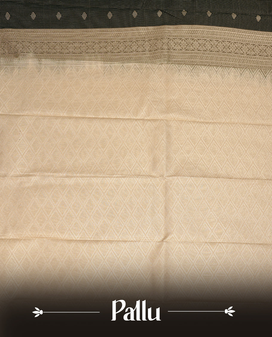 Dark green coloured soft silk saree featuring gold zari stripes and motifs across the body, enhanced with a contrast cream border and pallu, paired with a matching contrast blouse piece.
