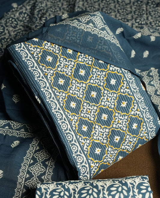 Greyish blue colour cotton churidar material featuring intricate white and mustard thread block prints on the body, complemented by a beautifully printed dupatta and matching printed fabric for the bottom.