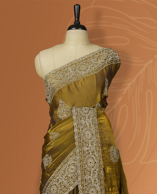 Dark yellow colour velvet chiffon designer saree in elegant two tone shades, featuring light gold zari, kodi work with handwoven style thread aari & dori embroidery work, Swarovski stone work and all over motifs, comes with matching blouse.