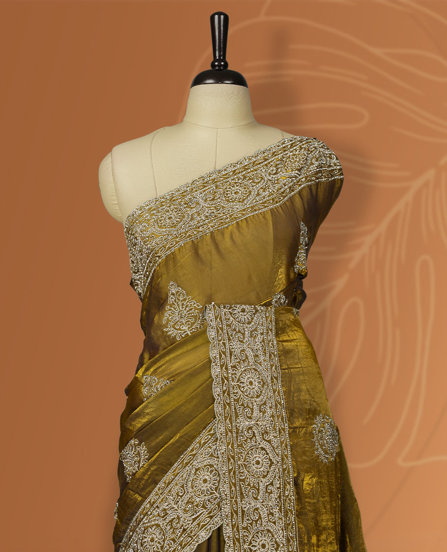 Dark yellow colour velvet chiffon designer saree in elegant two tone shades, featuring light gold zari, kodi work with handwoven style thread aari & dori embroidery work, Swarovski stone work and all over motifs, comes with matching blouse.