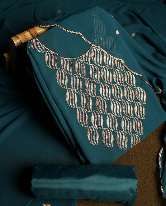 Teal blue colour churidar material adorned with intricate sequin embroidery on the neckline and body & dupatta comes with embroidered motifs and matching scalloped embroidered border & and plain bottom.