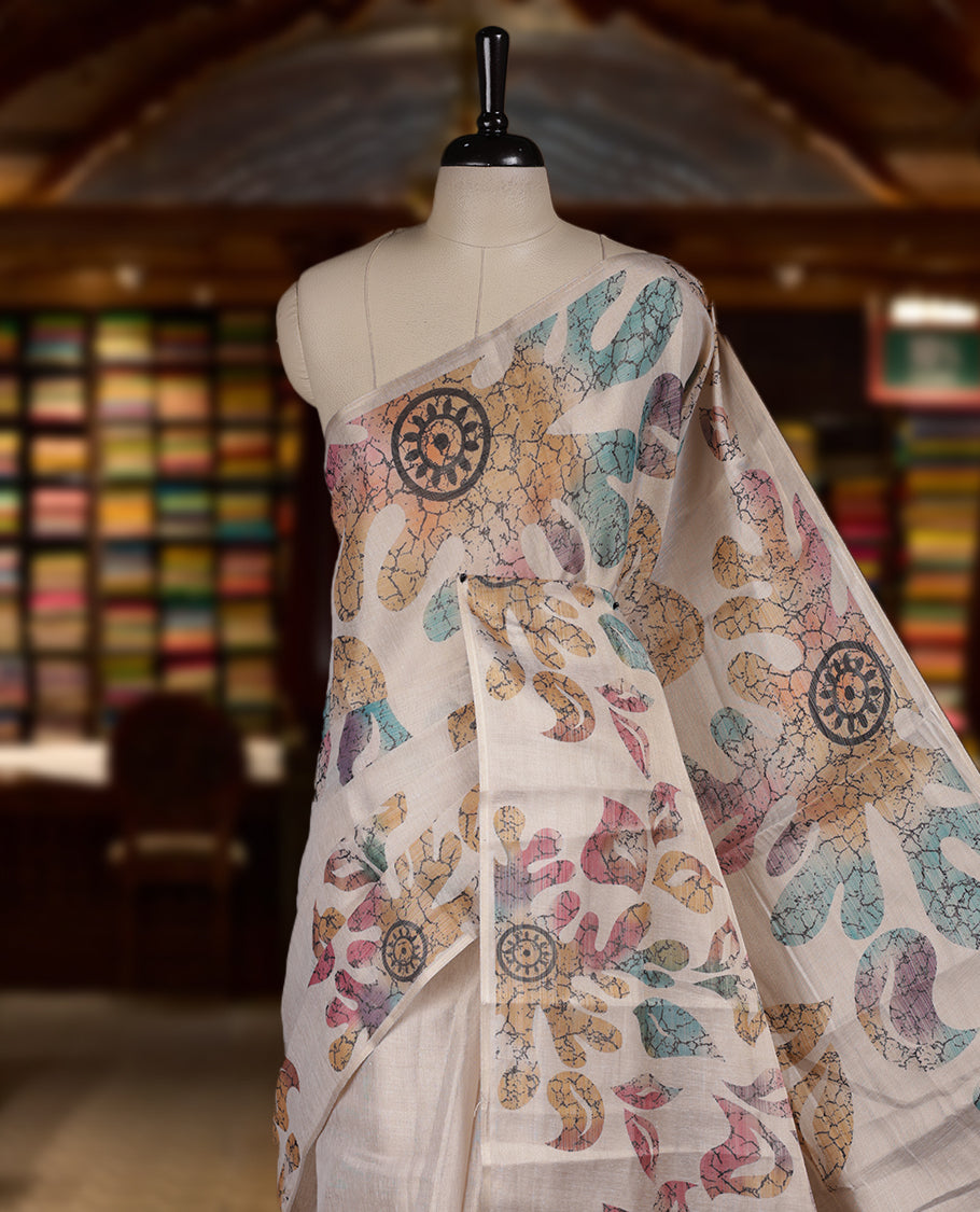 Beige colour Semi tissue saree adorned with Multi colour digital Leaf Design on the body and an elegant pallu & comes with a matching blouse piece