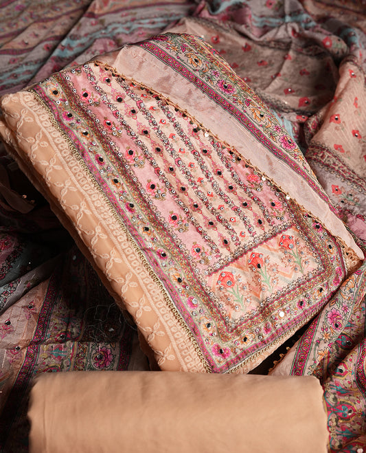 Peach colour churidhar material featuring Mirror and thread embroidery, foral print pattern on the self colour front panel, floral digital printed dupatta with elegant border, and matching plain bottom