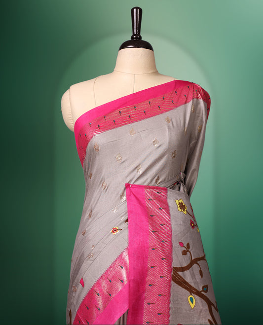 Grey colour saree adorned with delicate woven motifs on the body, enhanced with a vibrant Pink border, complemented by a colourful printed pallu featuring floral and bird designs, and paired with a matching blouse