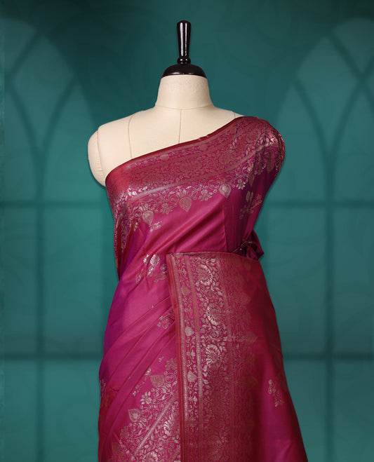 Pink colour semi silk saree featuring intricate golden zari floral motifs across the body, complemented by a rich maroon woven border and pallu, paired with a matching blouse.