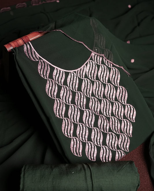 Deep green colour churidar material adorned with intricate sequin embroidery on the neckline and body & dupatta comes with embroidered motifs and matching scalloped embroidered border & and plain bottom.