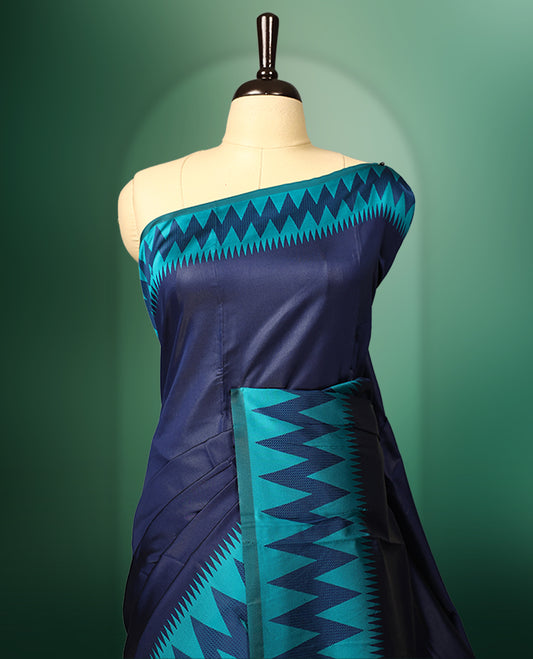 Navy blue colour saree adorned with bold turquoise zigzag woven patterns along the border and pallu, finished with a rich metallic woven design, paired with a matching blouse
