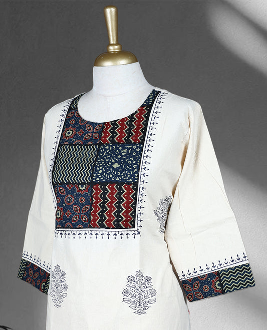Cream colour cotton cord set with navy blue floral prints, highlighted by vibrant patchwork on the yoke and sleeve borders, Paired with matching straight pants.