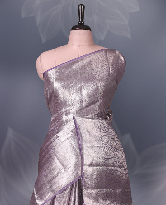 Lavender Pure tissue Banaras saree featuring intricate silver zari weaving all over with a rich pallu and bold paisley motifs, offering a luxurious drape perfect for weddings, festive occasions, and grand celebrations