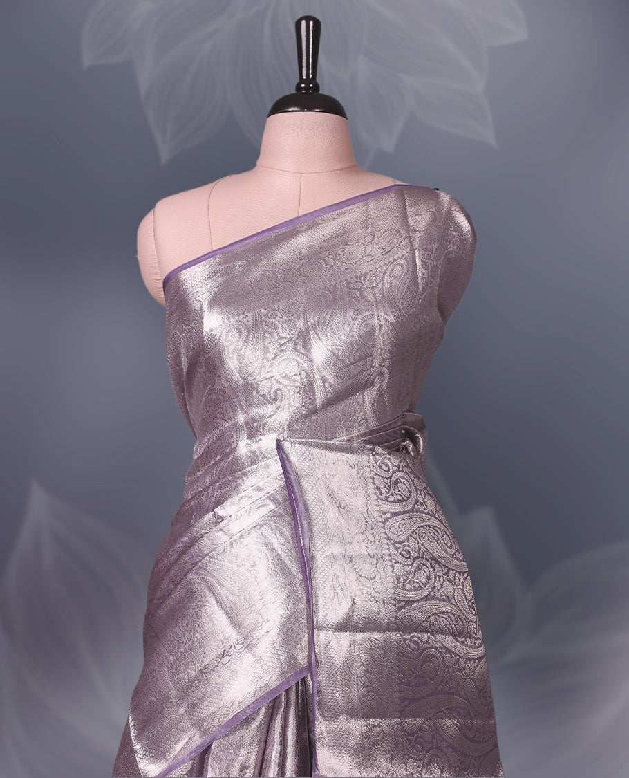 Lavender Pure tissue Banaras saree featuring intricate silver zari weaving all over with a rich pallu and bold paisley motifs, offering a luxurious drape perfect for weddings, festive occasions, and grand celebrations