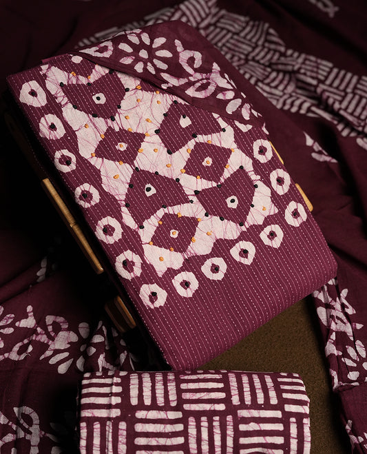 Wine & Off white cotton churidar material adorned with black & yellow colour thread work on the neckline, featuring traditional tie dye patterns and a stripped body & Comes with a matching printed dupatta and coordinated printed  bottom.