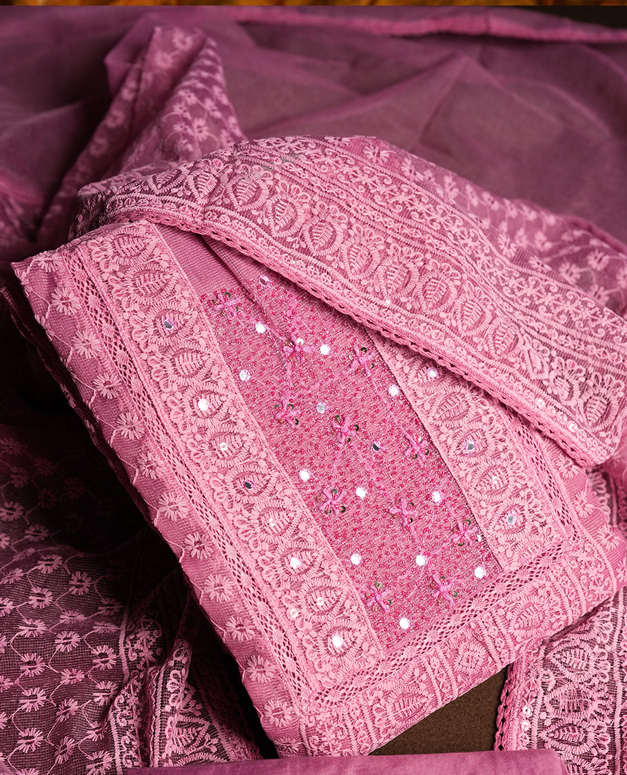 Soft Pink colour churidar material featuring intricate thread embroidery with mirror & cut beads work on the front panel, paired with an all over embroidered net dupatta and matching bottom.