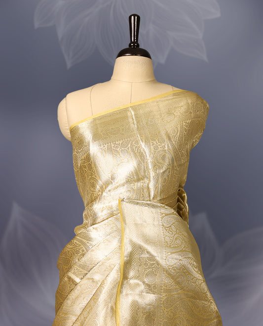 Golden Pure tissue Banaras saree featuring exquisite zari weaving throughout the body with a grand pallu highlighted by bold paisley motifs, making it a luxurious choice for weddings, festive occasions, and grand celebrations