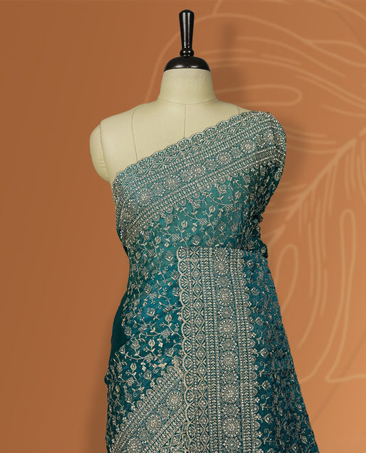 Sky blue colour velvet chiffon designer saree in elegant two tone shades, featuring light gold zari, kodi work with handwoven style thread aari & dori embroidery work, Swarovski stone work and all over motifs, comes with matching blouse.