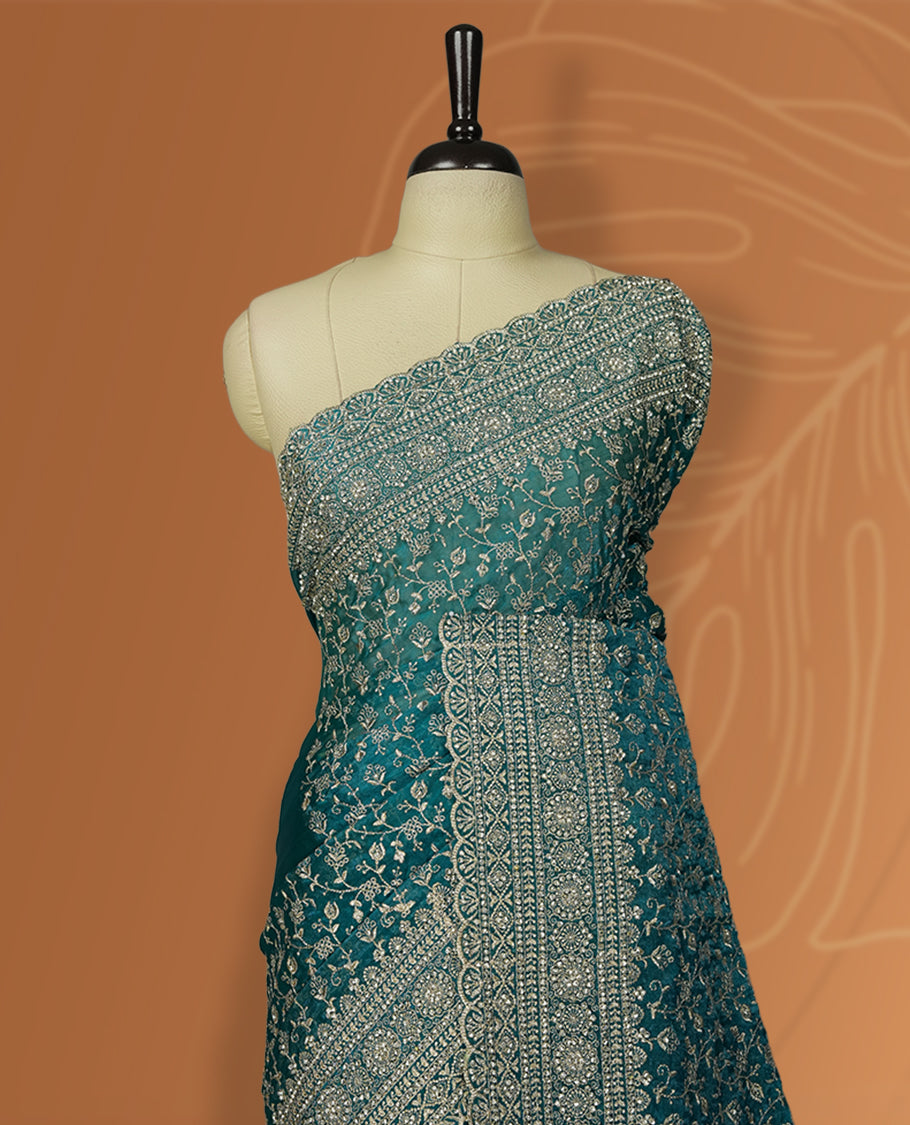Sky blue colour velvet chiffon designer saree in elegant two tone shades, featuring light gold zari, kodi work with handwoven style thread aari & dori embroidery work, Swarovski stone work and all over motifs, comes with matching blouse.