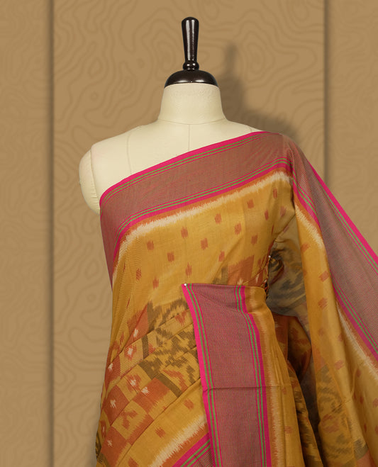 Mustard yellow colour Ikkat Pochampally saree adorned with traditional woven motifs, paired with a striking pink border and pallu, finished with a matching blouse piece for a vibrant and elegant ethnic look.