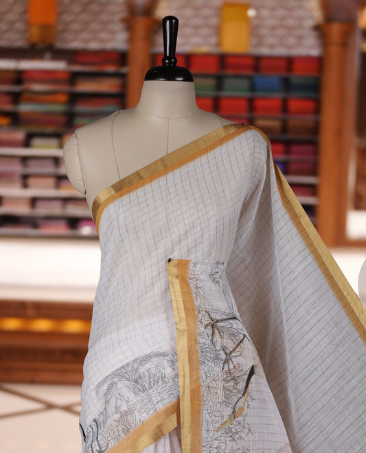 Off white colour Soft cotton saree featuring elegant bird prints along the edges, a stylish checked body, and a beautifully designed yellow border & Paired with a matching blouse piece.