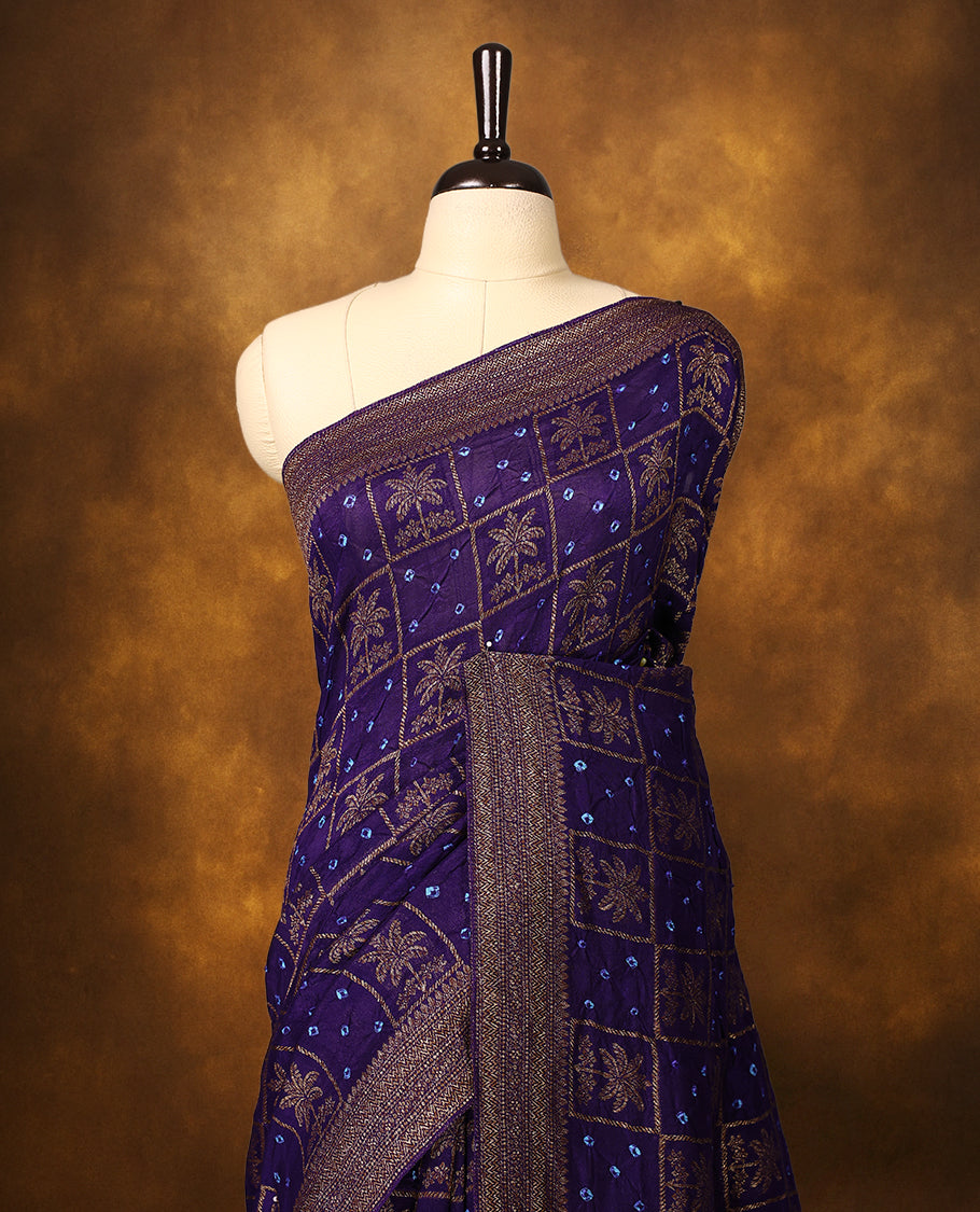 Indigo Banarasi Bandhani saree with golden zari motifs in checkered Bandhani body, detailed zari woven border, and rich pallu with tassels. A perfect blend of tradition and festive grace.