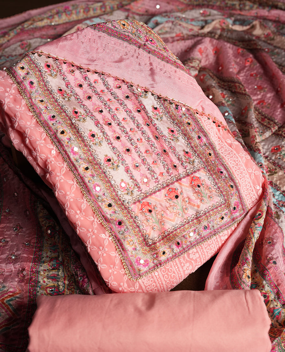 Pink colour churidhar material featuring Mirror and thread embroidery, foral print pattern on the self colour front panel, floral digital printed dupatta with elegant border, and matching plain bottom