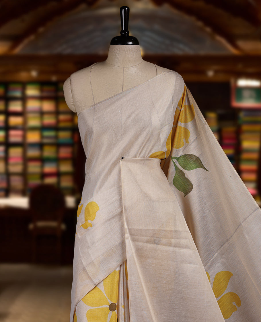 Beige colour Semi tissue saree adorned with Yellow colour digital Bold Floral Design on the body and an elegant pallu & comes with a matching blouse piece