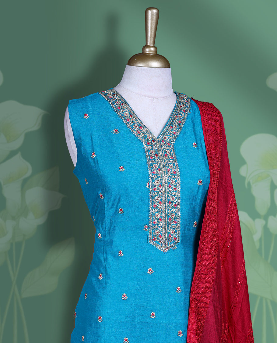 Bright blue colour churidar set featuring elegant white & red thread embroidery on the neckline, sleeveless, and scattered motifs across the body, Paired with a contrast rani pink colour plain dupatta