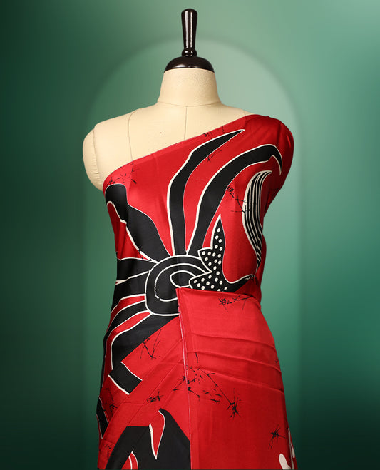 Red and black colour semi modal saree featuring bold abstract floral and swirl patterns, highlighted with contemporary design elements, and paired with a coordinated blouse